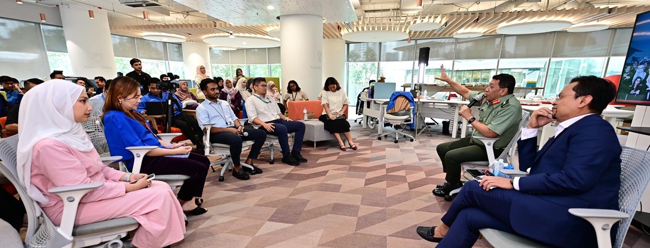 picture showing employees listening to talks by management